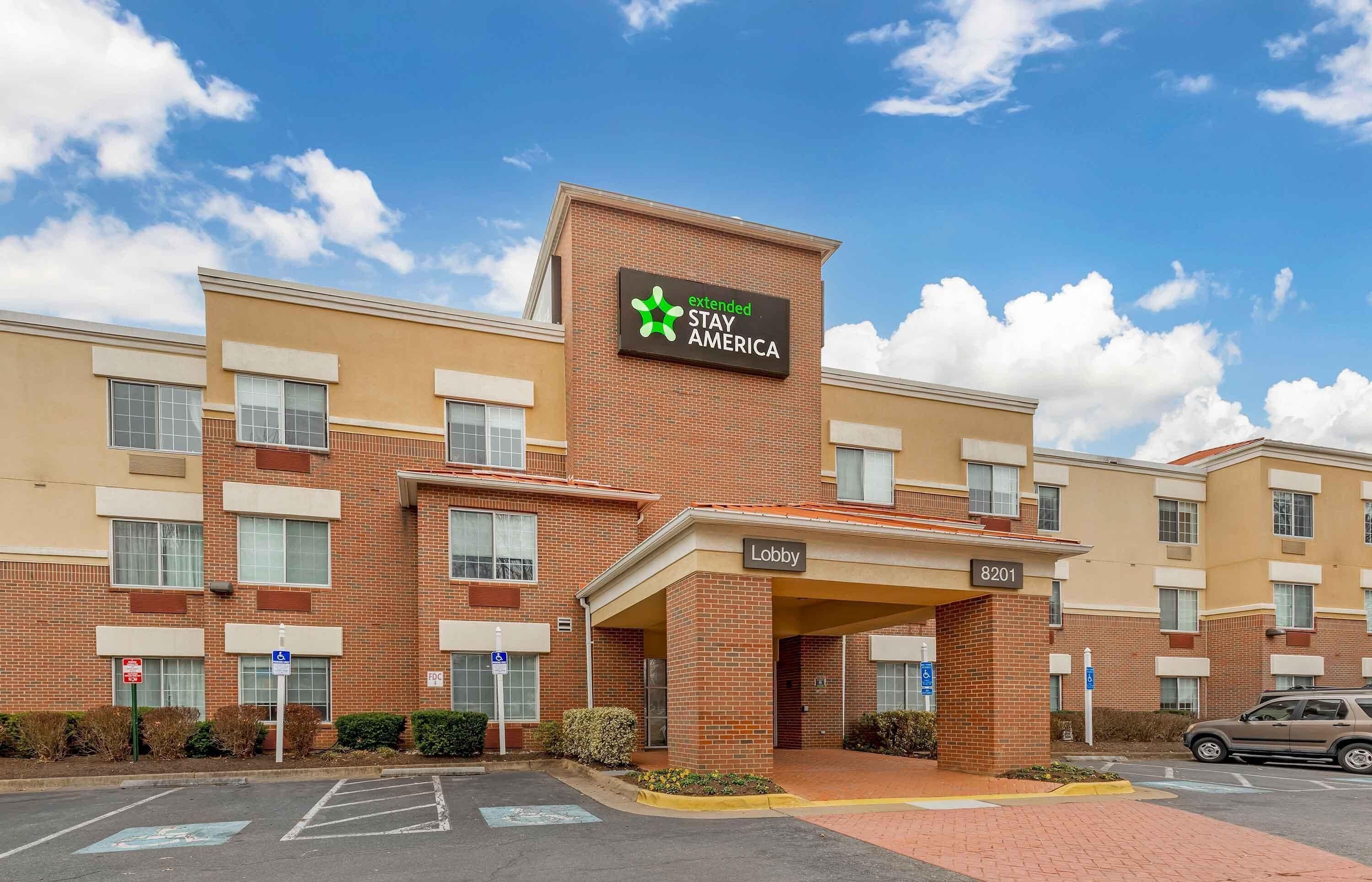 A hotel with a sign reading 'extended STAY AMERICA' and a 'Lobby' sign.