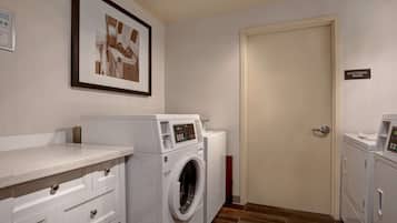 A laundry room with a washing machine, dryer, and a door labeled "ELECTRICAL ROOM".