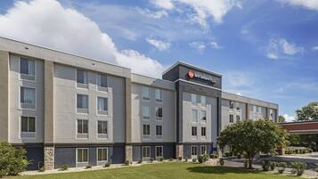 A modern hotel building with a sign reading "Best Western Plus."