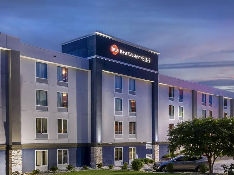 A modern hotel building with a sign reading "Best Western PLUS".