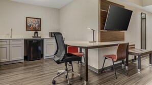 A modern kitchen with a built-in refrigerator, a coffee machine, and a painting on the wall. - Best Western Plus Lexington Inn (Lexington)