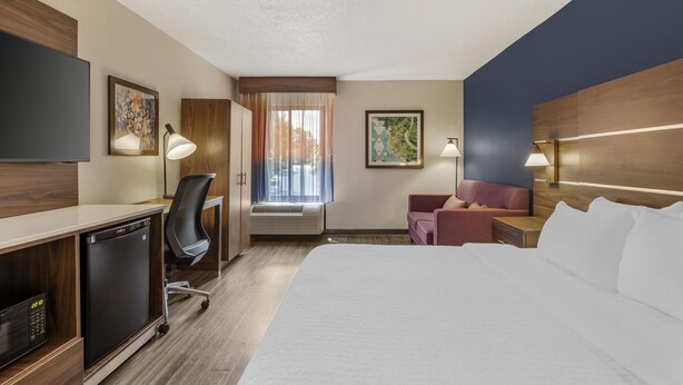 A hotel room with a bed, desk, chair, and a television. - Best Western Plus Lexington Inn (Lexington)