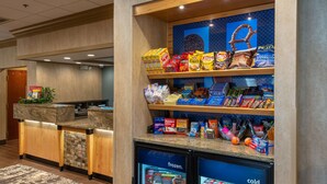A self-service snack and beverage station with a variety of snacks, chips, and drinks. - Hampton Inn Wilkesboro (Wilkesboro)