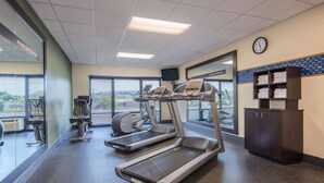 A gym with treadmills, exercise machines, and a clock on the wall. - Hampton Inn Wilkesboro (Wilkesboro)