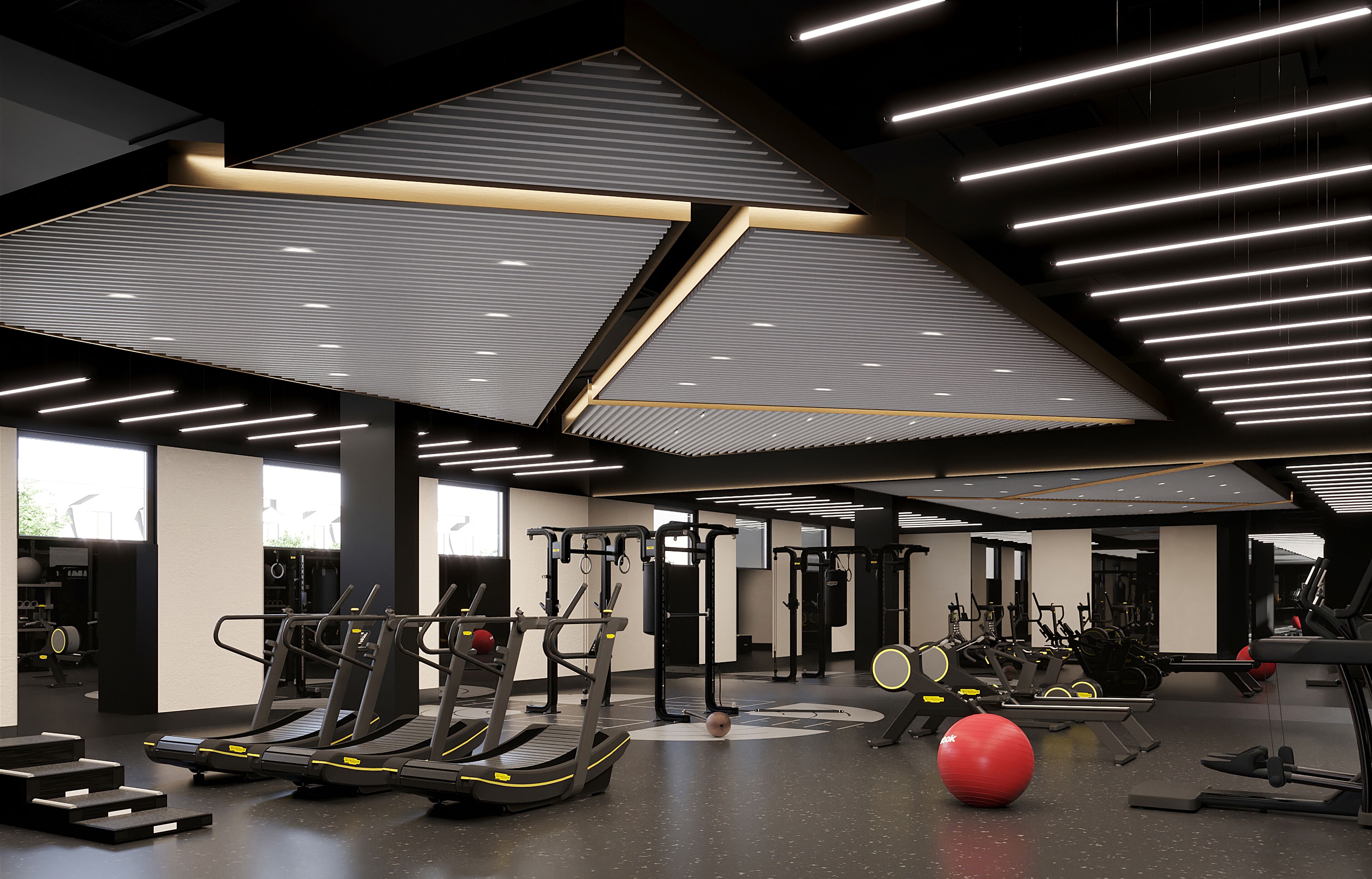 A modern gym with treadmills, weight machines, and exercise balls.