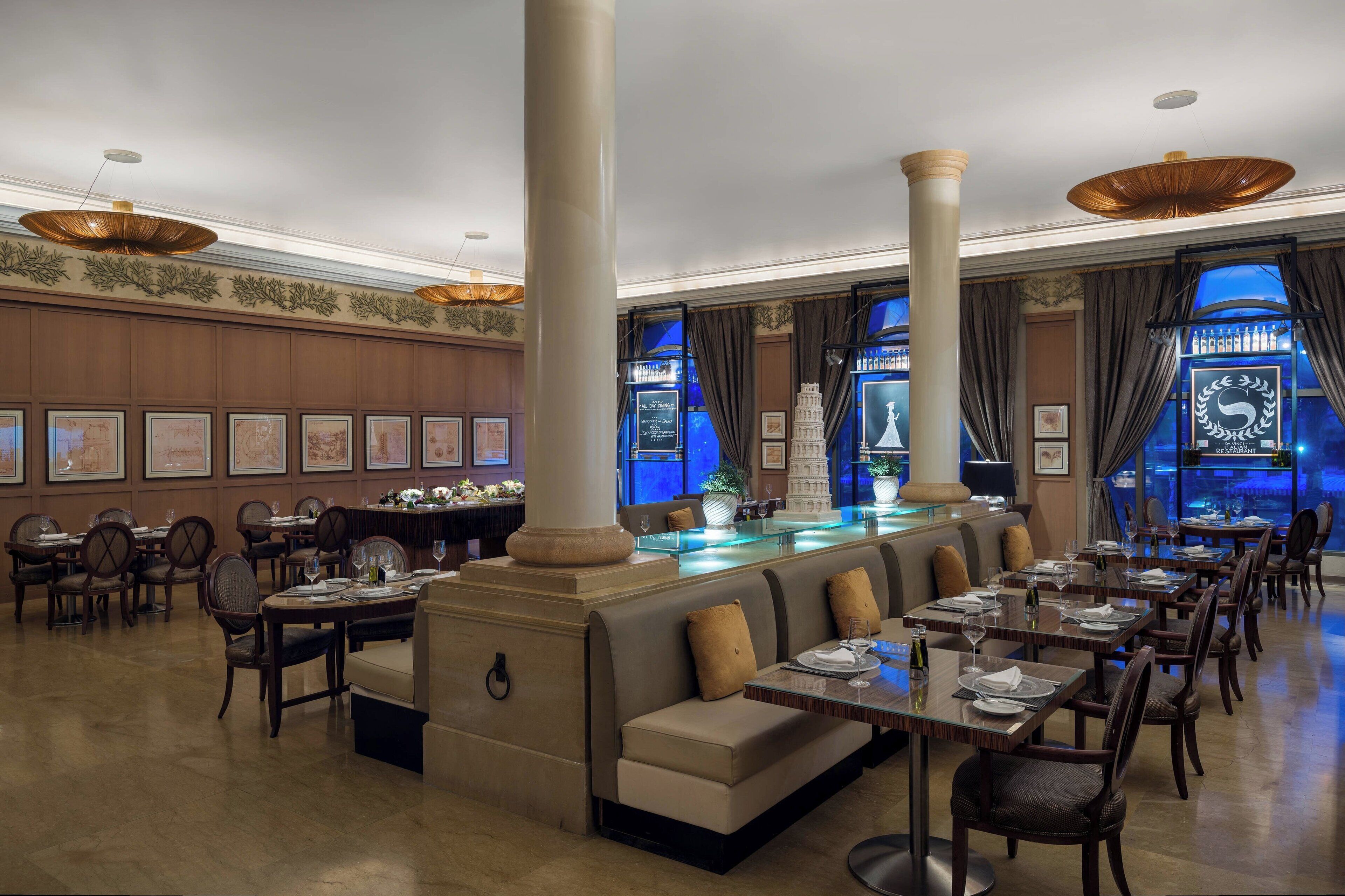 A spacious restaurant with high ceilings, large columns, and a central bar area.
