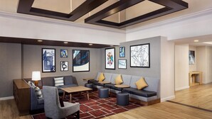 A modern lobby with a sofa, chairs, a coffee table, and artwork on the walls. - Hyatt Place Dublin/Pleasanton (Dublin)