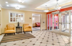 Relax in style at the reception area, featuring a comfortable seating space and a beautiful geometric floor design.