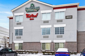 A building with a sign for 'HOMETOWNE Studios by RedRoof Inn' and a street address of 28500.