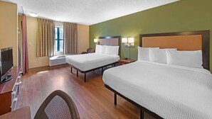 A hotel room with two beds, a desk with a television, and a window with curtains. - Extended Stay America Suites St Louis Westport Central (Maryland Heights)