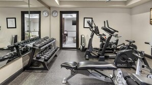 A gym with exercise equipment, a bench, and a rack of dumbbells. - Best Western Plus Heritage Inn (Houston)