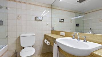 Un bagno con il water, un lavandino e uno specchio.