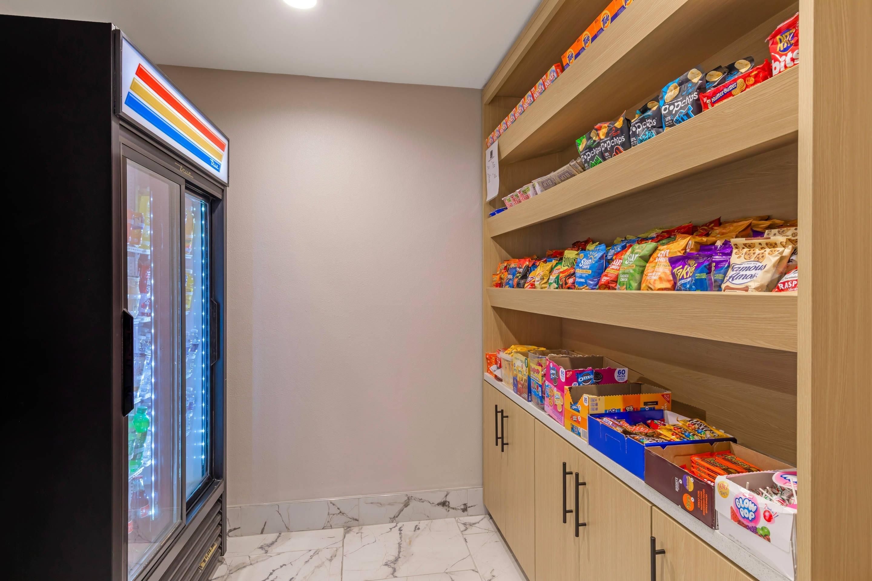 A snack storage area with shelves stocked with various packaged snacks.