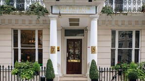 The entrance to The Premier Notting Hill, featuring a classic facade with a central entrance, double doors, and a sign above. - The Premier Notting Hill (London)