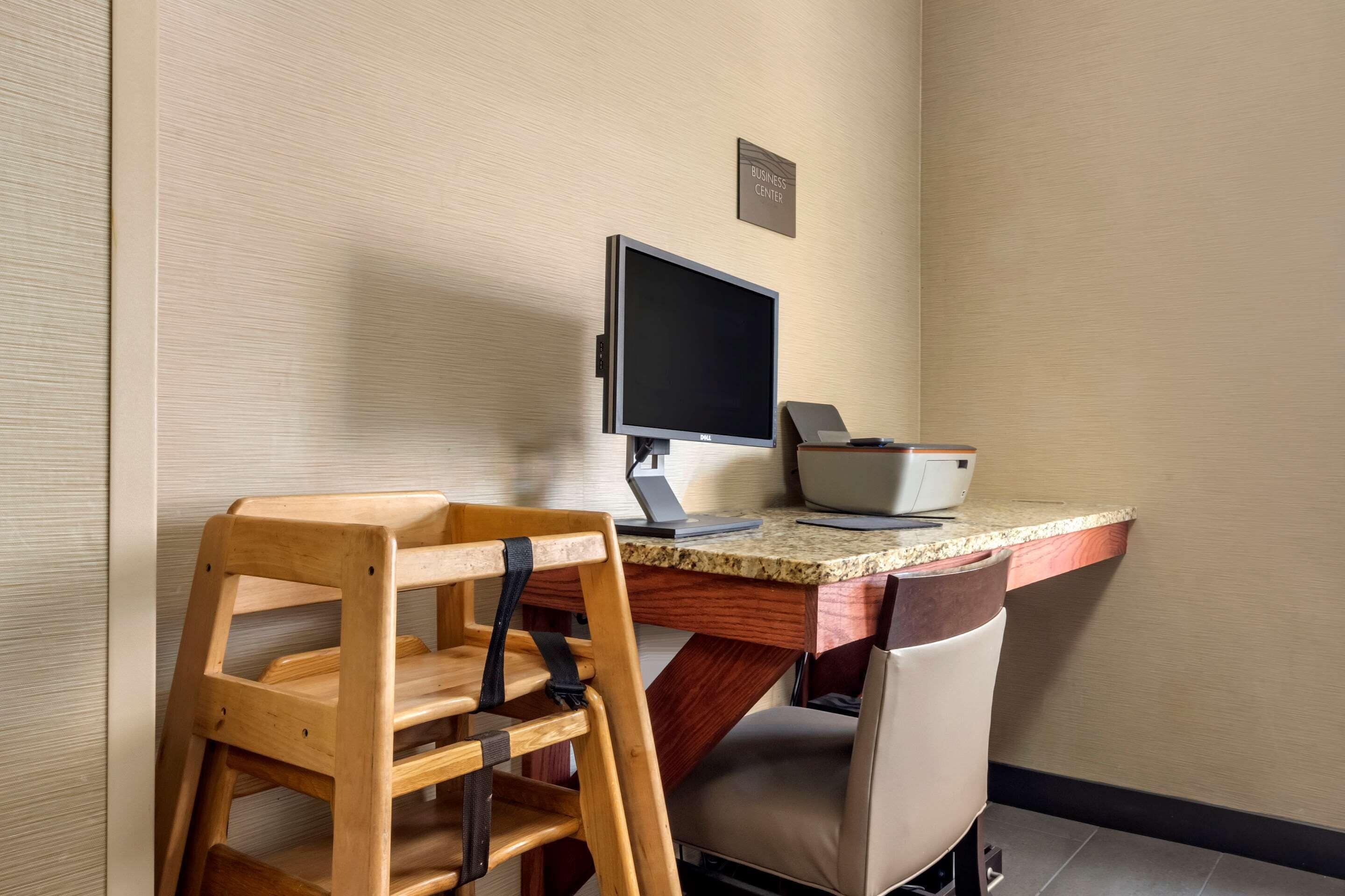 A workspace with a desk, computer, and a chair.