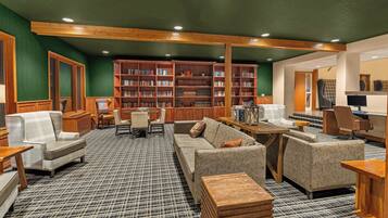 A library with bookshelves, seating areas, and a checkered floor.