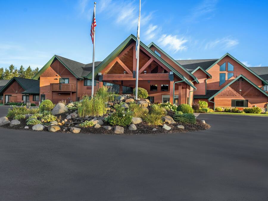 A lodge with a central entrance, multiple rooms, and a flagpole.