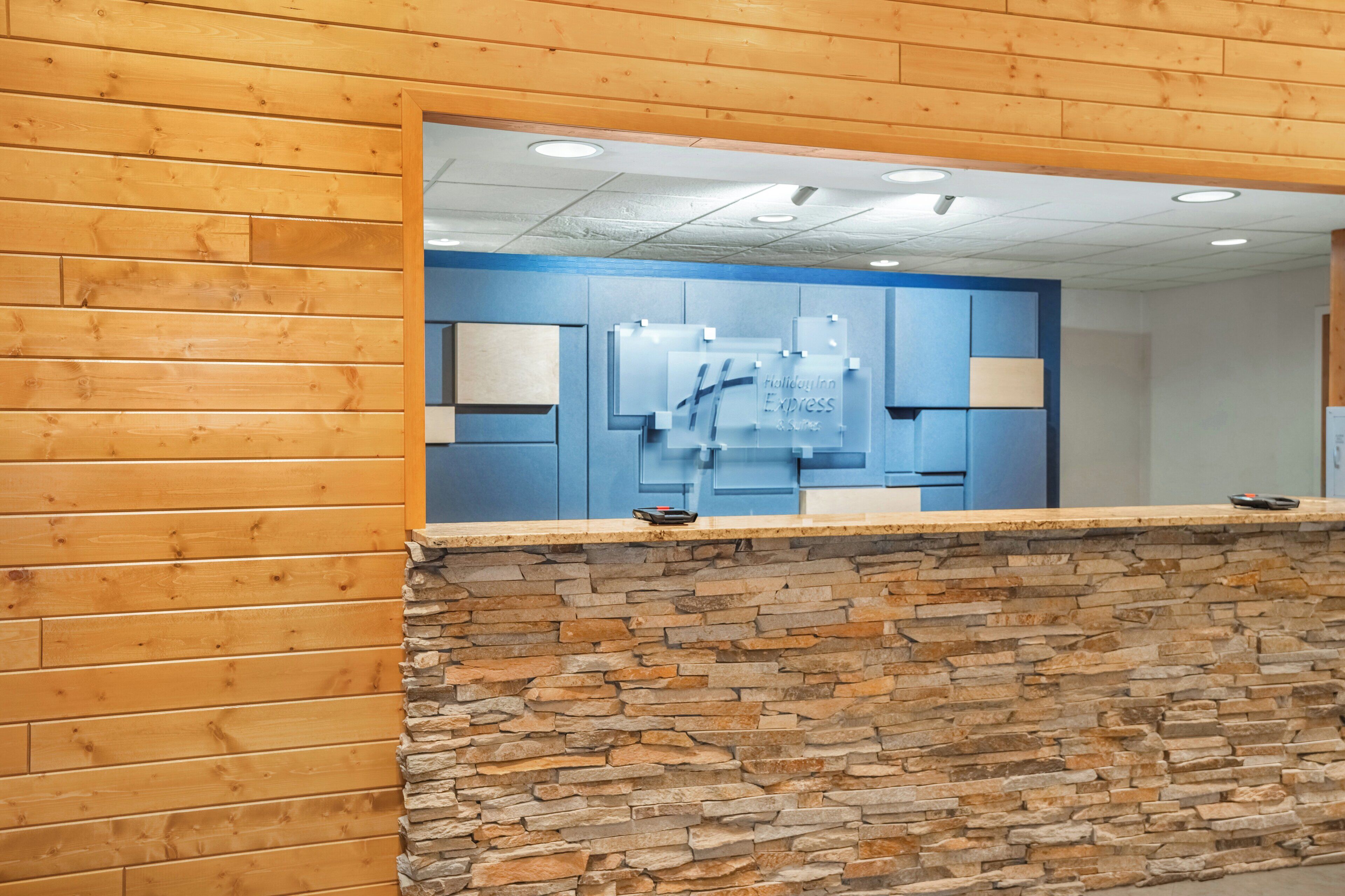 A reception area with a stone wall and wooden paneling.