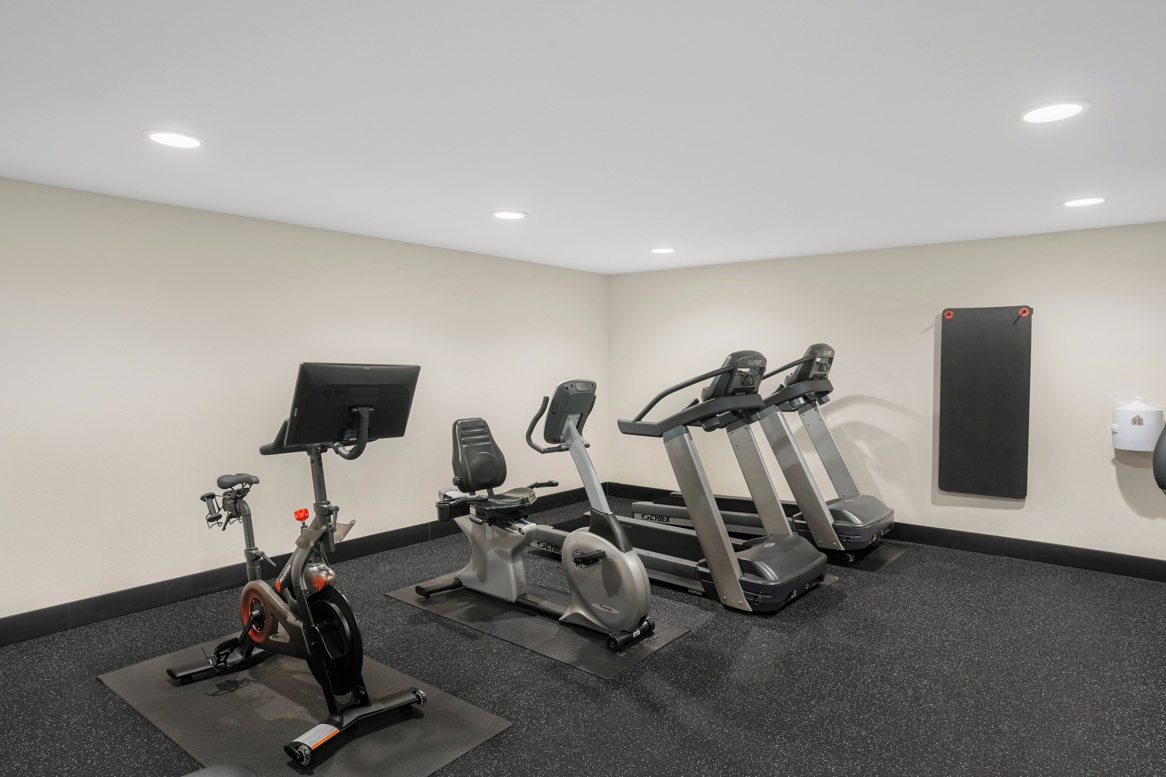 A gym with stationary bikes, an elliptical, and treadmills.