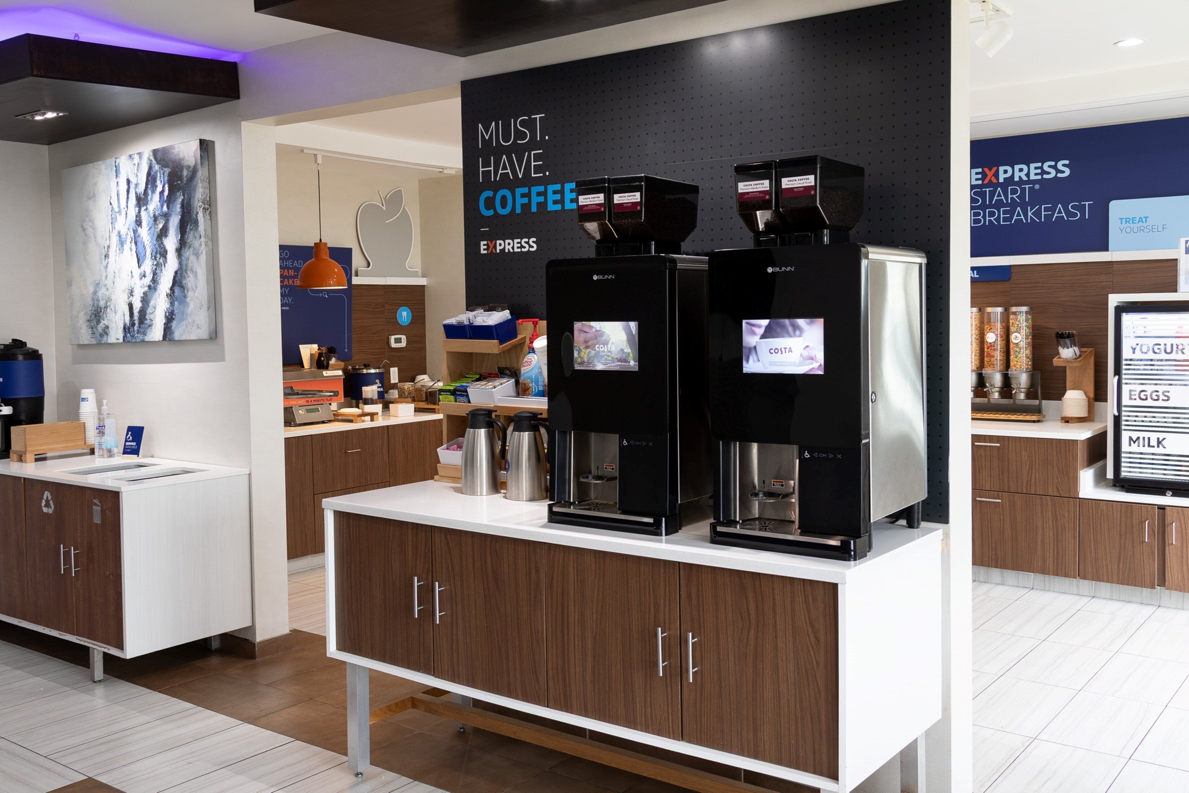 A coffee station with branded coffee machines and a sign that reads "MUST. HAVE. COFFEE."