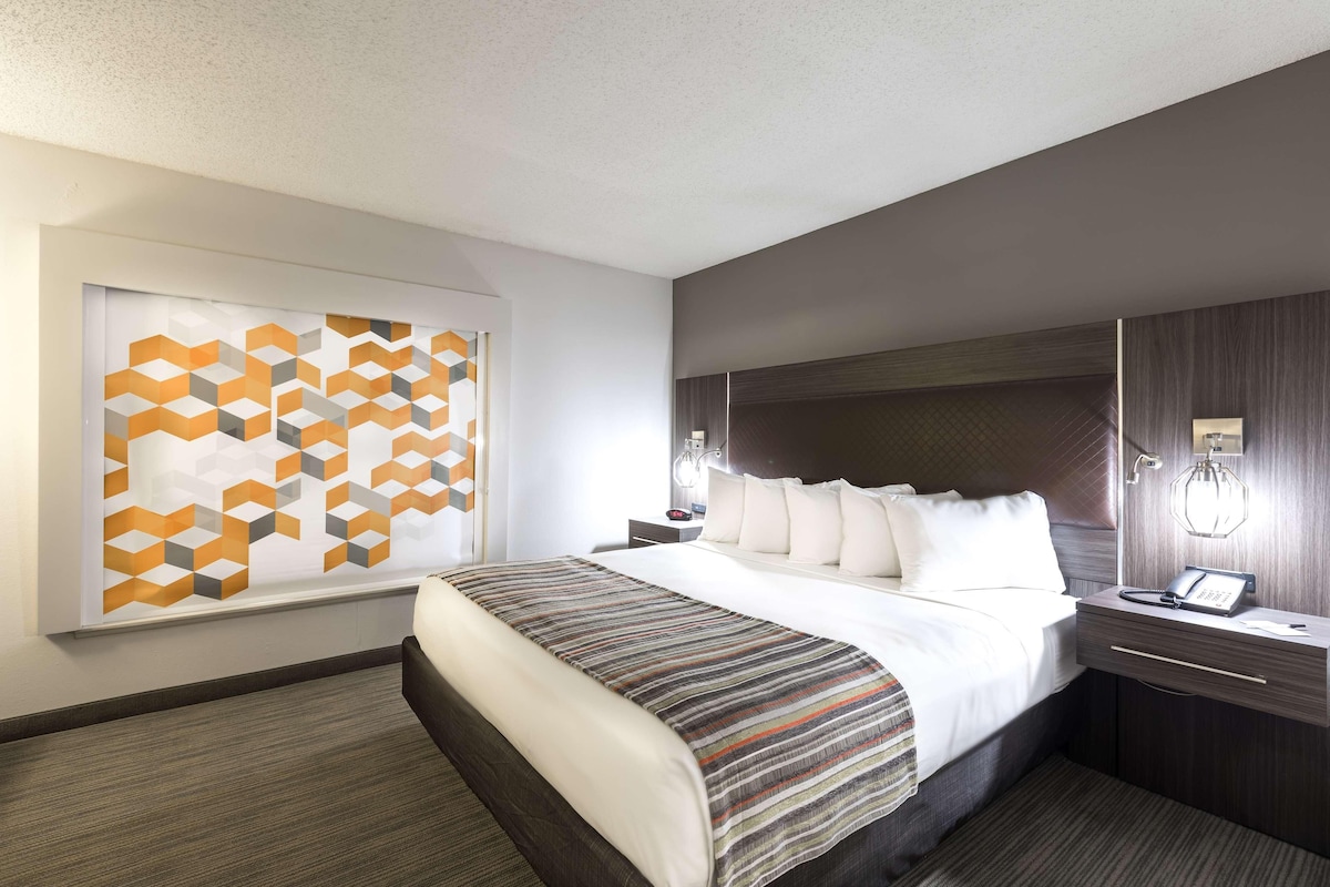 Premium bedding, desk, laptop workspace, blackout drapes
