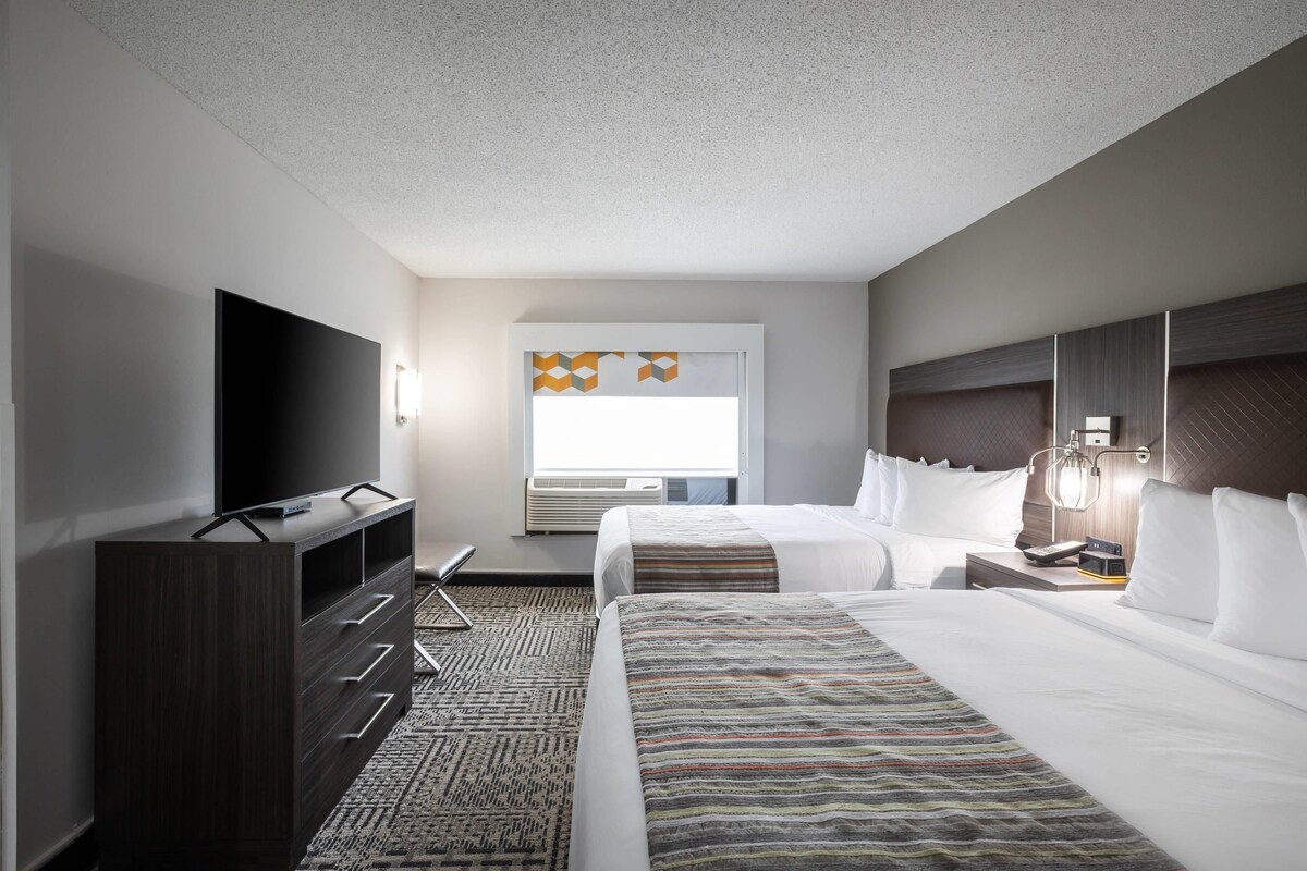 Premium bedding, desk, laptop workspace, blackout drapes