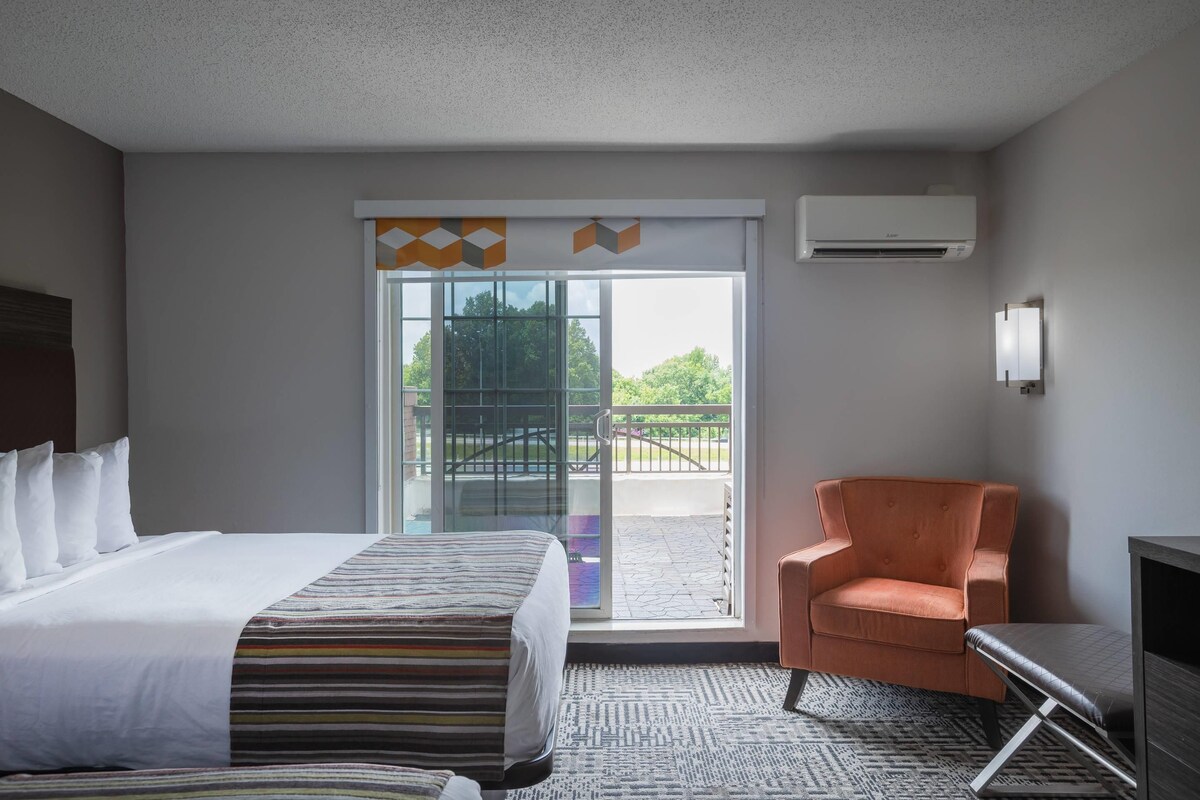 Premium bedding, desk, laptop workspace, blackout drapes