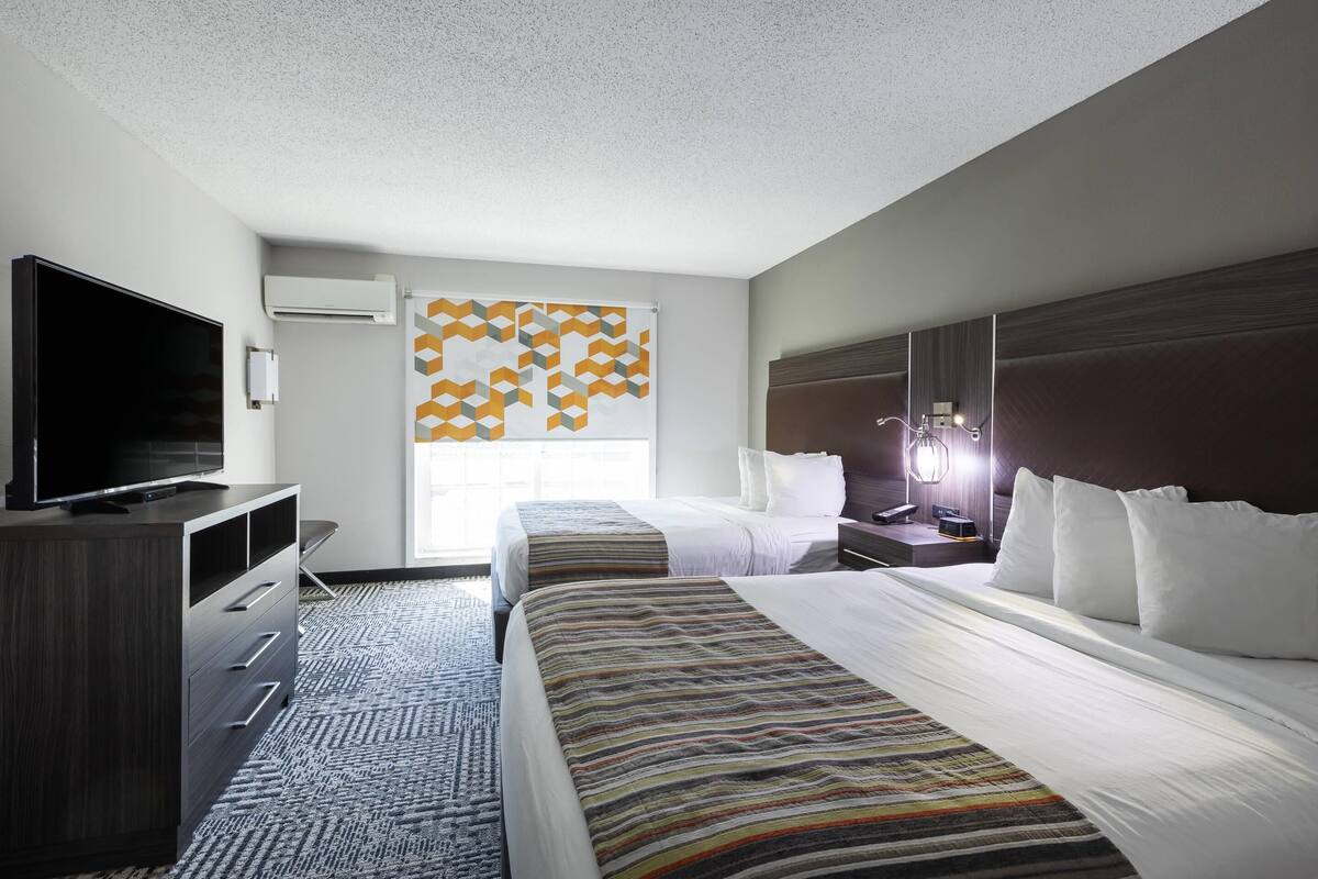 Premium bedding, desk, laptop workspace, blackout drapes