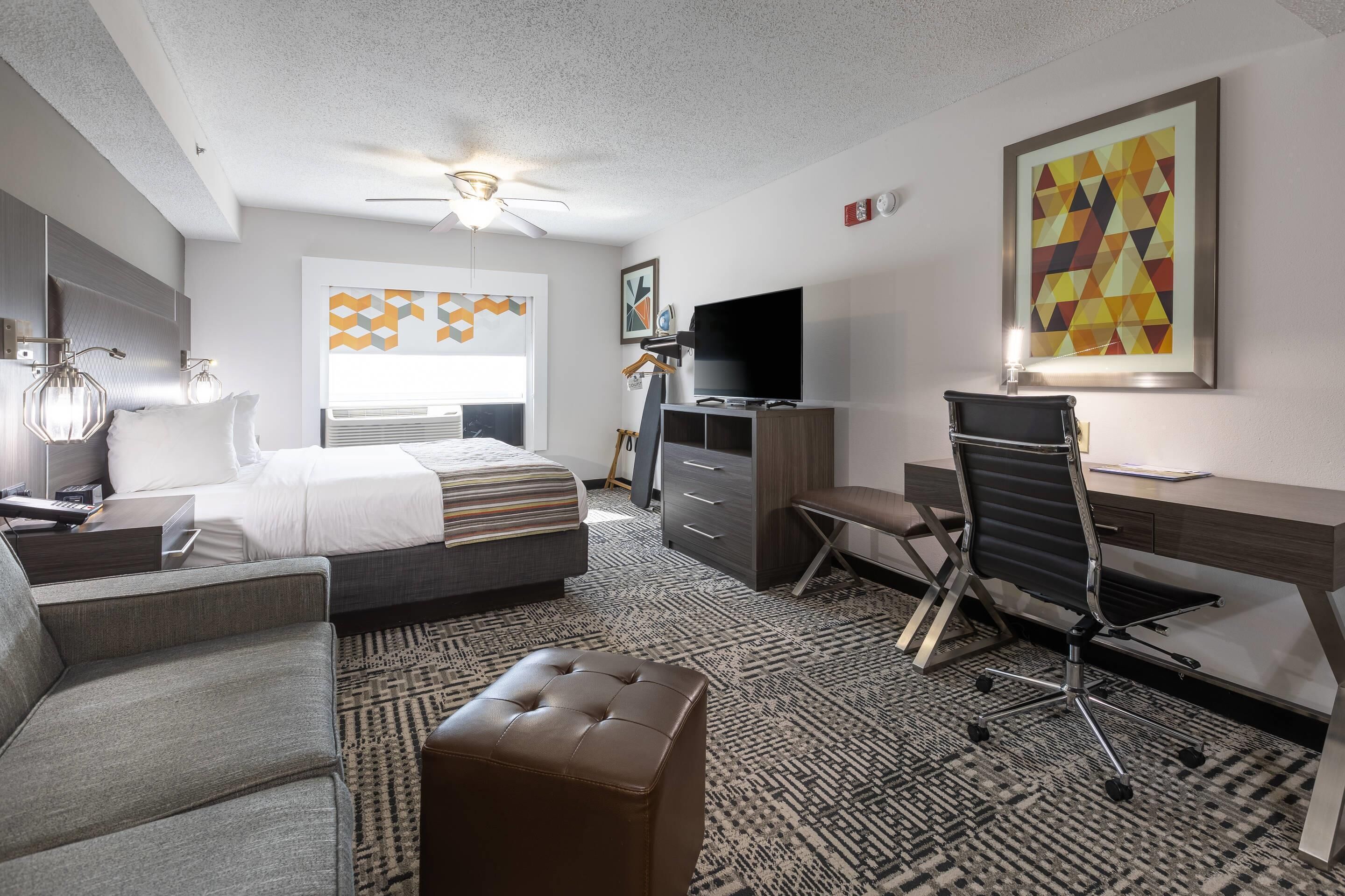 Premium bedding, desk, laptop workspace, blackout drapes
