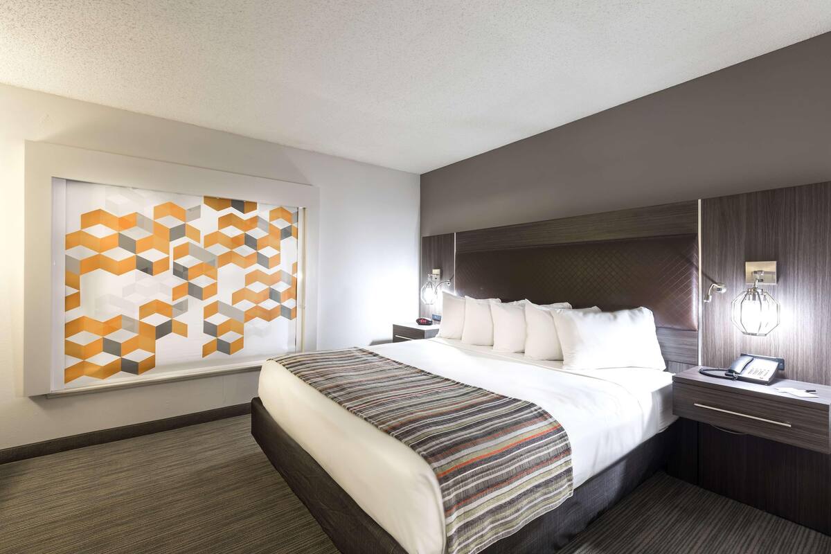 Premium bedding, desk, laptop workspace, blackout drapes