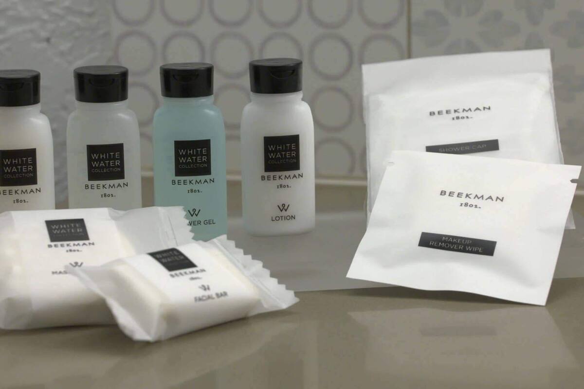 A collection of skincare products from the Beekman brand, including lotions, a facial bar, and a makeup remover wipe.