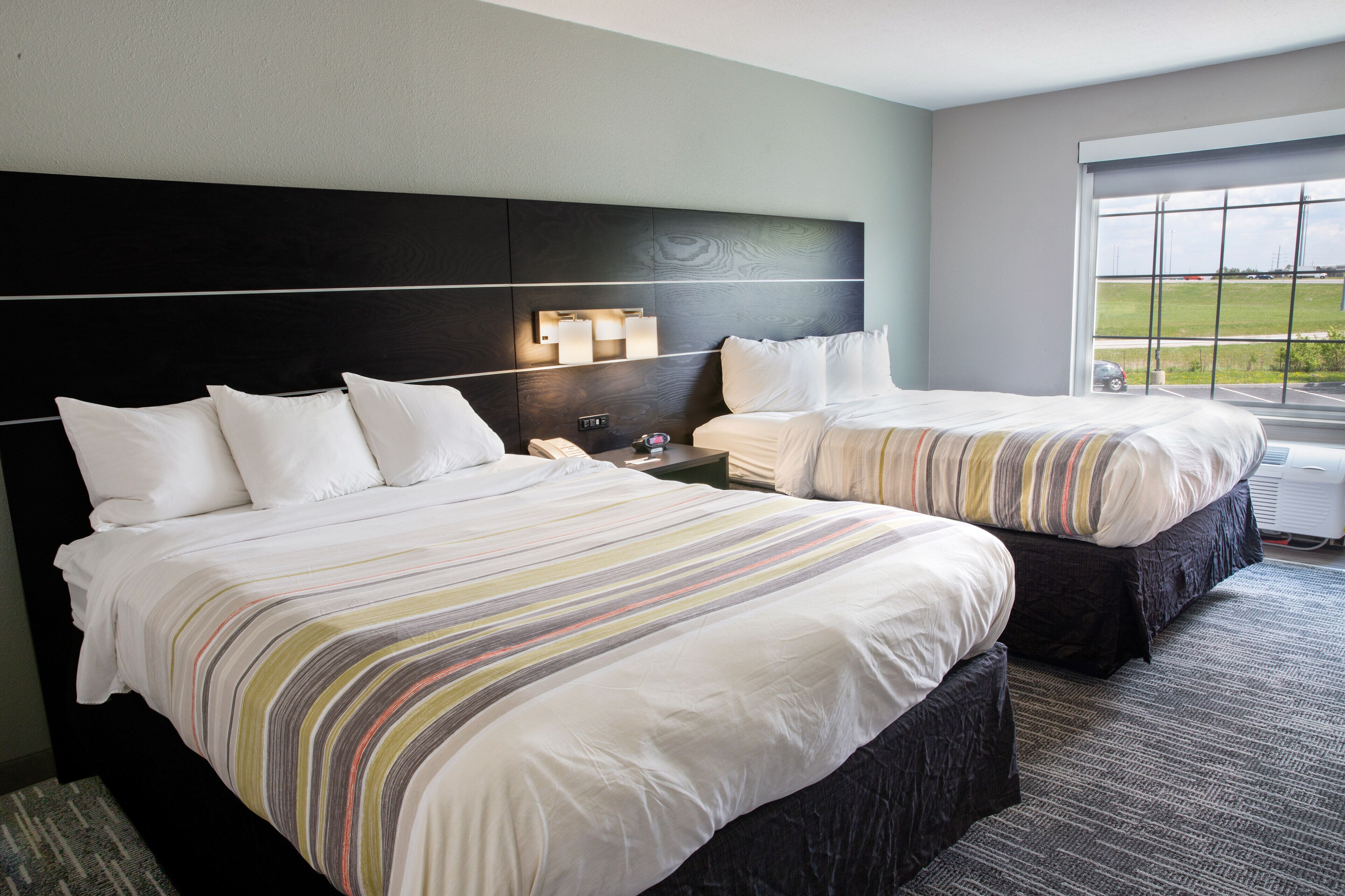 pillow-top beds, desk, laptop workspace, blackout curtains