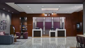 A modern lobby with a reception desk, seating area, and a vending machine. - Courtyard Portland Downtown/Convention Center (Portland)
