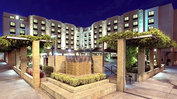 A modern hotel with a central courtyard, multiple floors, and a brick facade. - Courtyard Portland Downtown/Convention Center (Portland)