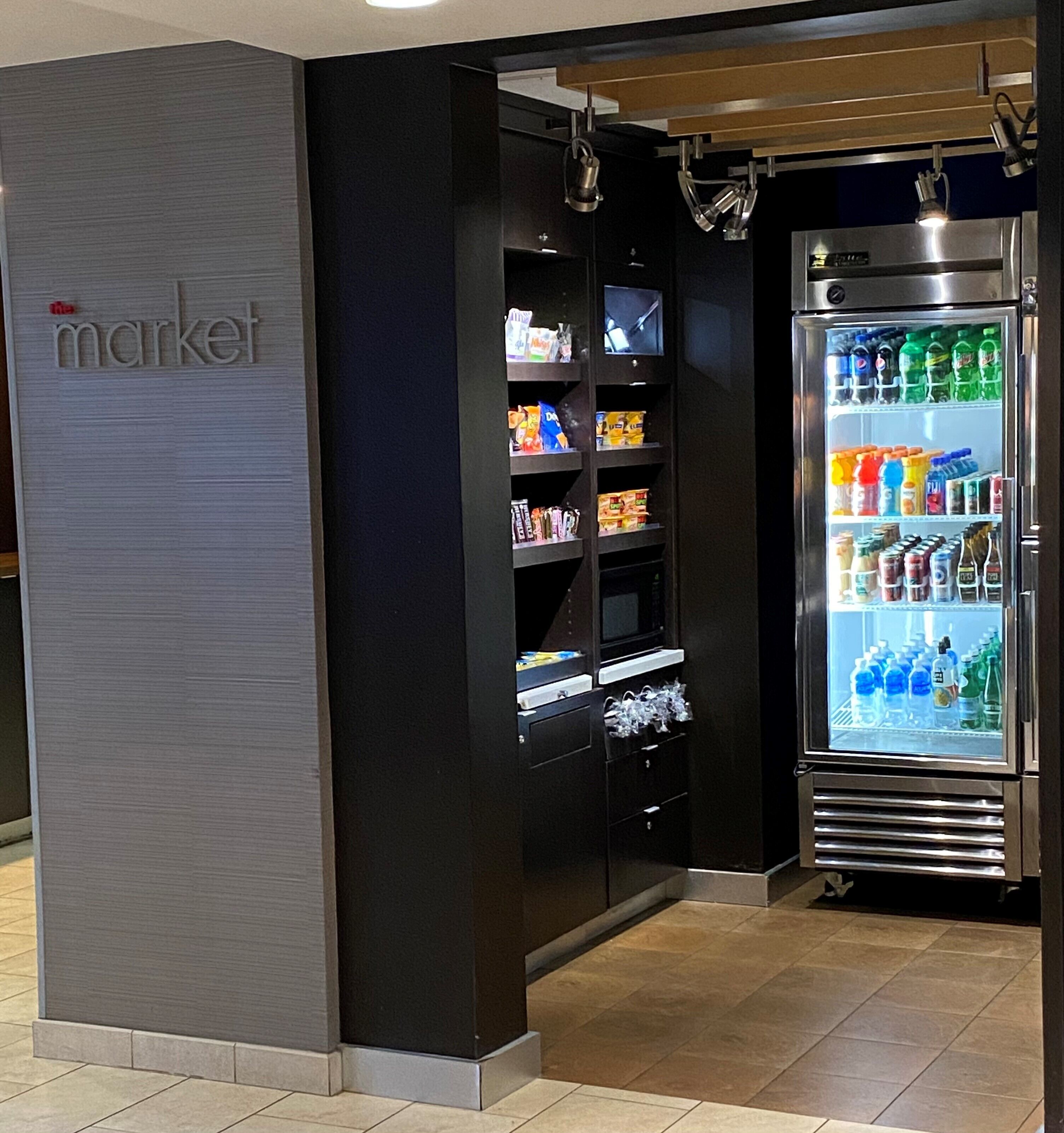 A self-service beverage kiosk with a variety of drinks and snacks.