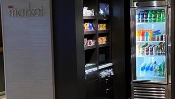 A self-service beverage kiosk with a variety of drinks and snacks.