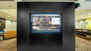 A GoBoard display in a hotel lobby with a map and flight information.