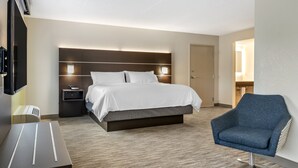 A modern hotel room with a large bed, bedside tables, a TV, and a seating area. - Holiday Inn Express Jonestown - Ft. Indiantown Gap by IHG (Jonestown)