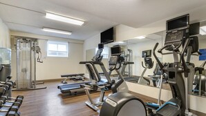 A gym with exercise equipment, a water dispenser, and a mirror. - Holiday Inn Express Jonestown - Ft. Indiantown Gap by IHG (Jonestown)