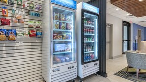 Two self-service beverage vending machines with a variety of snacks and drinks. - Holiday Inn Express Jonestown - Ft. Indiantown Gap by IHG (Jonestown)