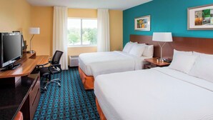 A hotel room with two beds, a desk with a television, a chair, and a window with curtains. - Fairfield Inn & Suites Dayton South (Dayton)