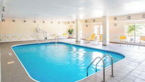 An indoor swimming pool with clear blue water, tiled floor, and sunlit interior. - Fairfield Inn & Suites Dayton South (Dayton)
