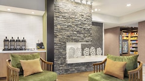 A lobby with a stone wall, a coffee station, and a snack bar. - Fairfield Inn by Marriott Tracy (Tracy)