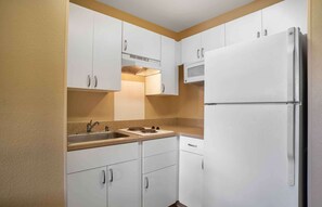 Full-size fridge, microwave, stovetop, coffee/tea maker
