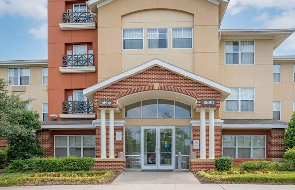 A multi-story building with a central entrance, a lobby area, and a numbered address.