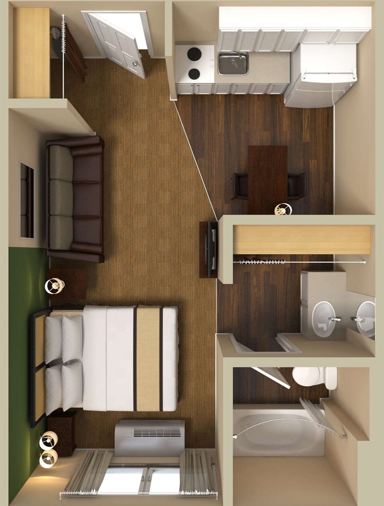 A compact hotel room with a bed, a small kitchenette, a bathroom, and a seating area.