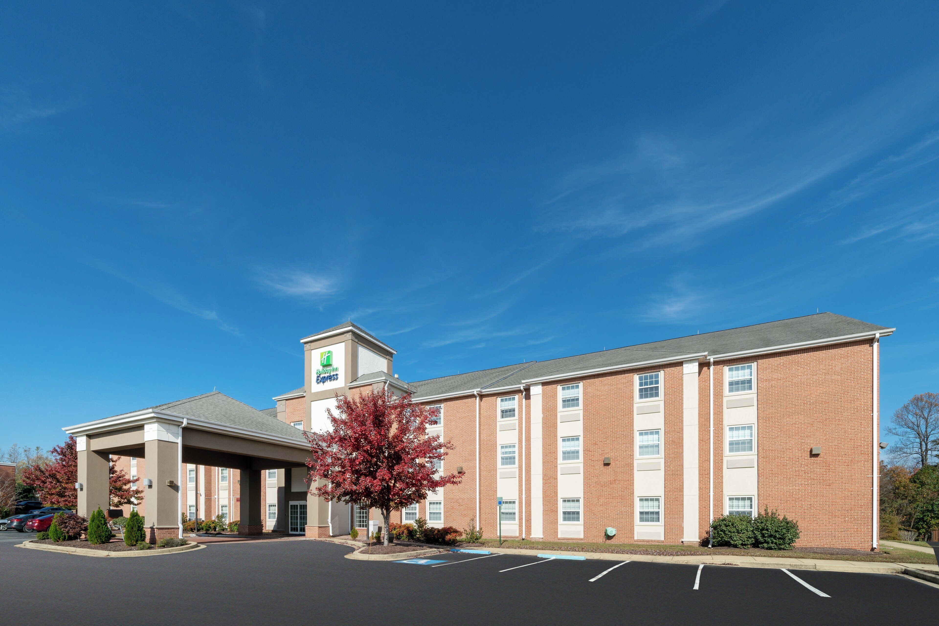 A Holiday Inn Express hotel with a covered parking area and a brick facade.