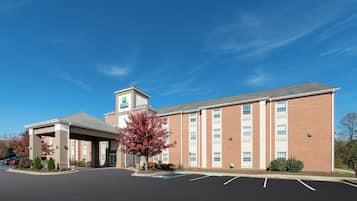 A Holiday Inn Express hotel with a covered parking area and a brick facade.
