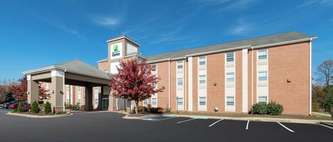 A Holiday Inn Express hotel with a covered parking area and a brick facade.