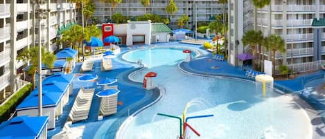 A hotel with multiple swimming pools, sun loungers, and a water slide.